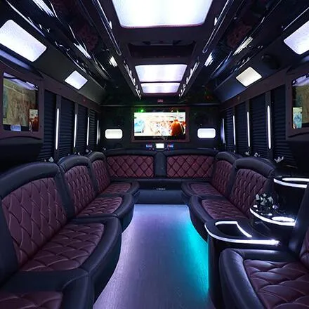 Party bus lounge interior with quilted leather seating and LED lighting