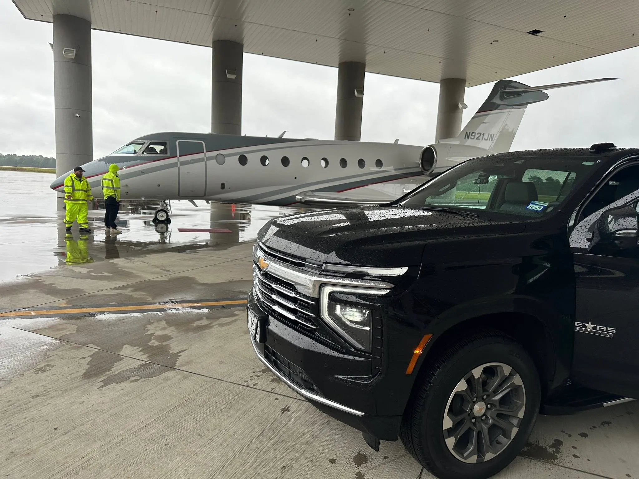 B N Lux Ride Chevrolet Suburban on the tarmac beside a private aircraft